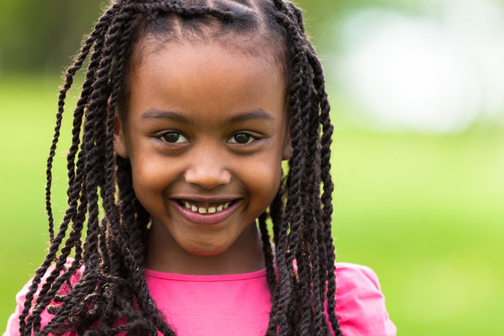 Outdoor close up portrait of a cute young black girl smiling - fufagist